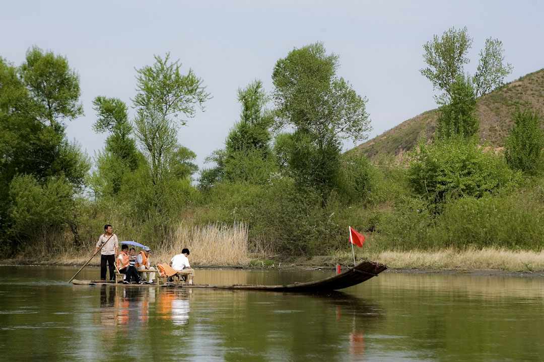 JILIN PROVINCE, CHINA - May 08: Chinese tourists tour a boat trip on the Tumen river that takes them as close as 1 meter near North Korea to have a peep at the forbidden country, at the Chinese-North Korean border on May 8, 2009 in Tumen, Jilin province, China. On May 25, 2009, North Korea conducted a nuclear test - raising immediate international condemnation. The next day, it fired three short-range missiles, showing how little it cared about this condemnation. China is the one and only ally of North Korea. (Photo by Lucas Schifres/Getty Images)